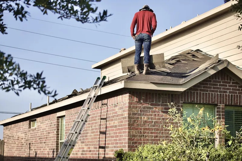 Professional roofer working on a residential roof in Lysander
